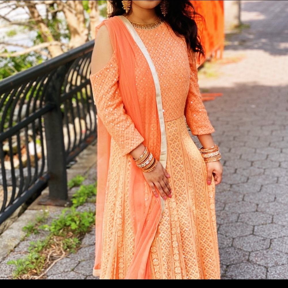 Beautiful Anarkali style gown with heavy work through out. Fits like medium.